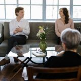My Partner Won't Do Couples Therapy - Exceptional Relationship Counseling for Virginia Couples a couple in a counselor's office sitting apart on the couch