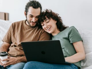 a couple sitting looking at a laptop for couples counseling in Ashburn