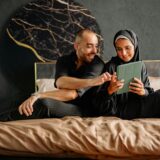 FAQs About the PREPARE-ENRICH Program: Updated - Exceptional Relationship Counseling for Virginia Couples a Muslim couple looking at a book together on a bed