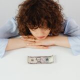 Why Couples Divorce - Exceptional Relationship Counseling for Virginia Couples a woman looking closeup at money on a table