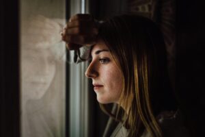 Self reflection in couples therapy and woman looking out window