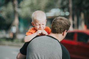 man carrying baby