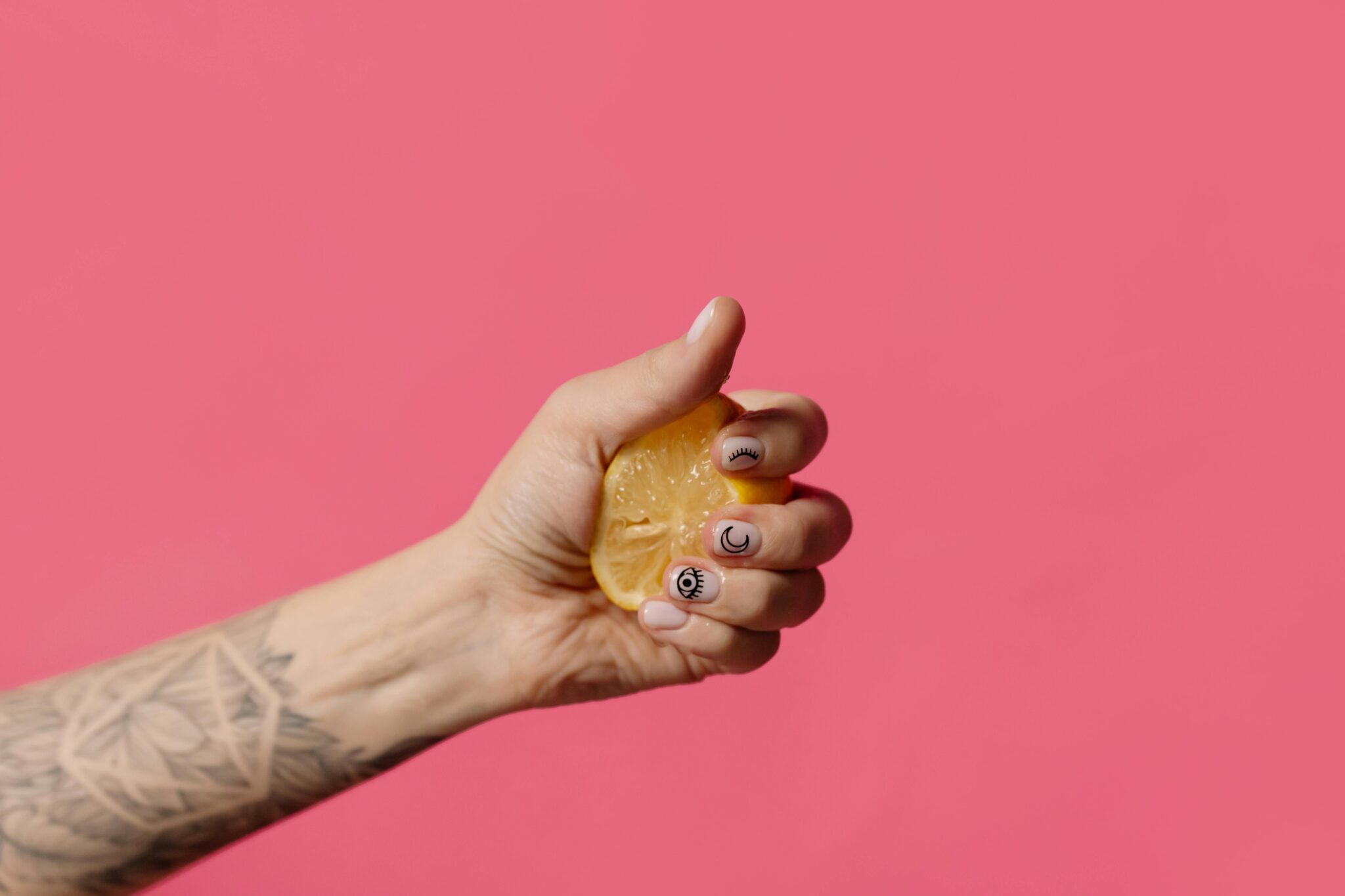 a hand squeezing a lemon