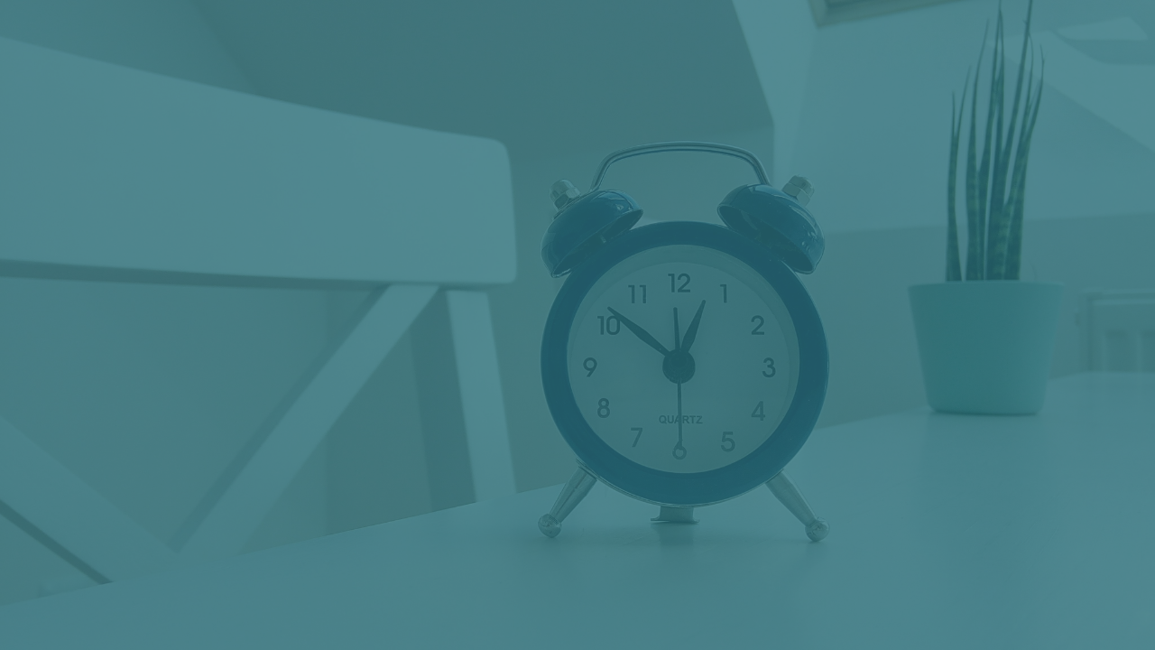 a blue alarm clock on a white table
