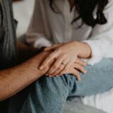 a man and woman holding each other's hands