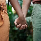 a close-up of a couple holding hands