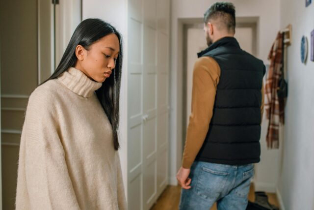 discernment counseling in virginia A couple experiencing relationship issues in a hallway, conveying emotional tension.