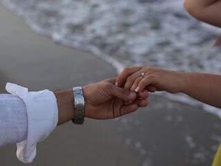 Premarital counseling Virginia Close-up of a couple holding hands by the sea